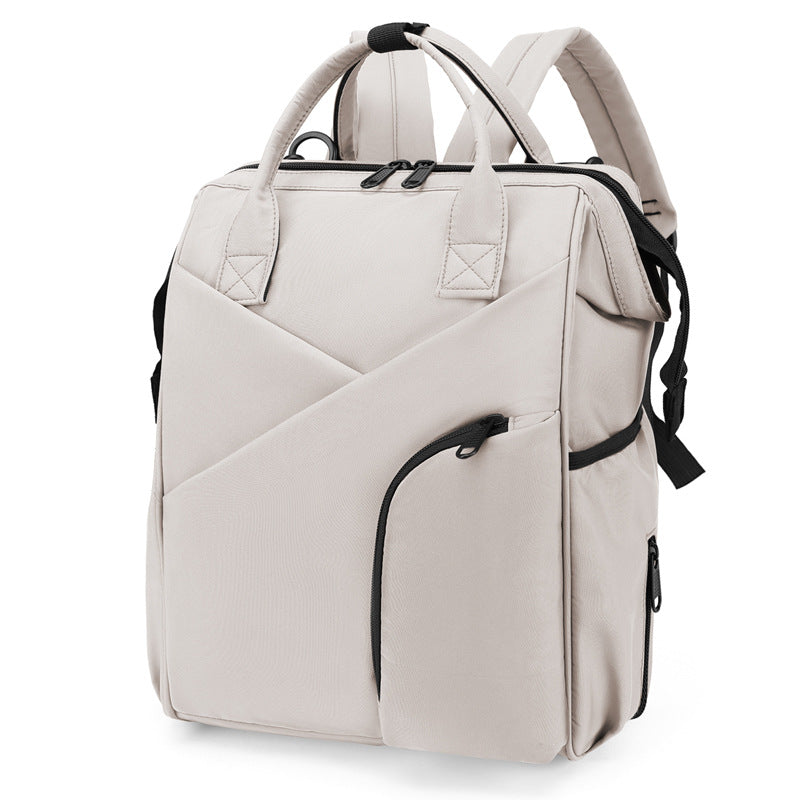 Beige diaper bag backpack with front zip pockets